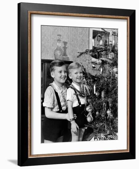 Two Brothers Look at a Christmas Tree in their Living Room in Germany, Ca. 1949-null-Framed Photographic Print