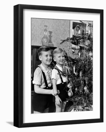 Two Brothers Look at a Christmas Tree in their Living Room in Germany, Ca. 1949-null-Framed Photographic Print