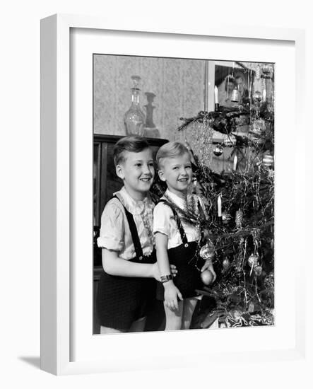 Two Brothers Look at a Christmas Tree in their Living Room in Germany, Ca. 1949-null-Framed Photographic Print