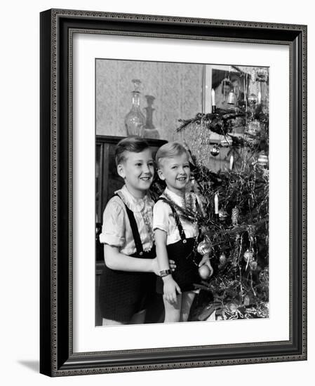 Two Brothers Look at a Christmas Tree in their Living Room in Germany, Ca. 1949-null-Framed Photographic Print
