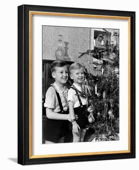 Two Brothers Look at a Christmas Tree in their Living Room in Germany, Ca. 1949-null-Framed Photographic Print