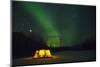 Two Campers Drinking a Bottle of Wine in a Tent under the Northern Lights-Jami Tarris-Mounted Photographic Print