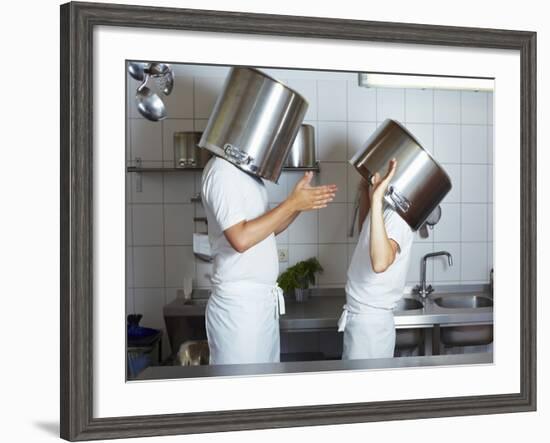 Two Chefs Having Discussion with Large Pans on their Heads-Robert Kneschke-Framed Photographic Print