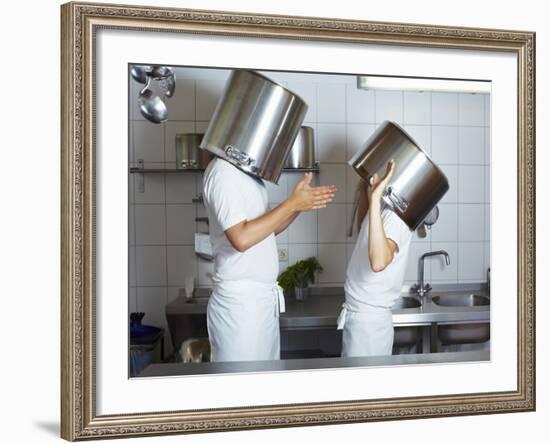 Two Chefs Having Discussion with Large Pans on their Heads-Robert Kneschke-Framed Photographic Print