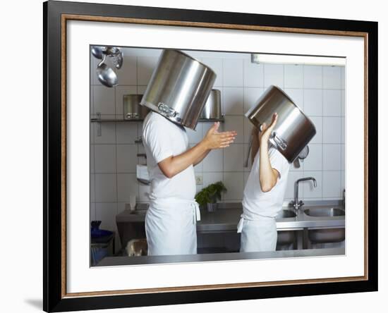 Two Chefs Having Discussion with Large Pans on their Heads-Robert Kneschke-Framed Photographic Print