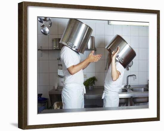 Two Chefs Having Discussion with Large Pans on their Heads-Robert Kneschke-Framed Photographic Print