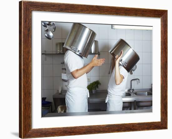 Two Chefs Having Discussion with Large Pans on their Heads-Robert Kneschke-Framed Photographic Print