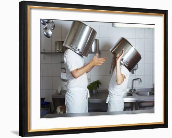 Two Chefs Having Discussion with Large Pans on their Heads-Robert Kneschke-Framed Photographic Print