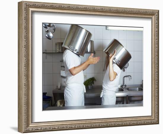 Two Chefs Having Discussion with Large Pans on their Heads-Robert Kneschke-Framed Photographic Print