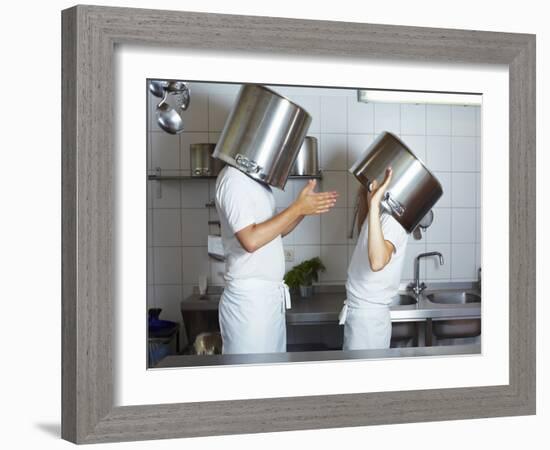 Two Chefs Having Discussion with Large Pans on their Heads-Robert Kneschke-Framed Photographic Print