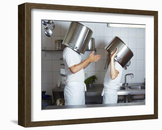 Two Chefs Having Discussion with Large Pans on their Heads-Robert Kneschke-Framed Photographic Print