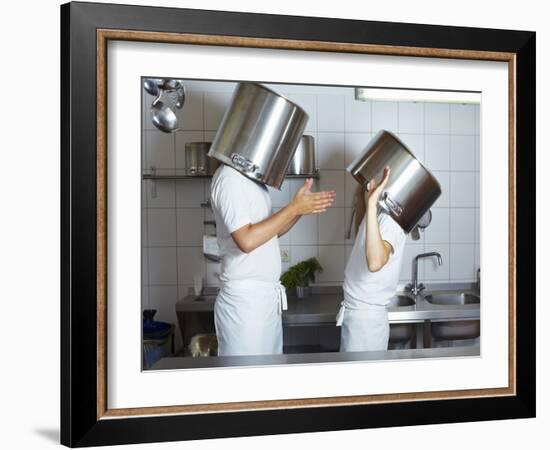 Two Chefs Having Discussion with Large Pans on their Heads-Robert Kneschke-Framed Photographic Print