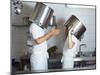 Two Chefs Having Discussion with Large Pans on their Heads-Robert Kneschke-Mounted Photographic Print