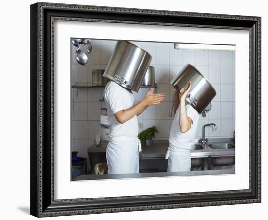 Two Chefs Having Discussion with Large Pans on their Heads-Robert Kneschke-Framed Photographic Print