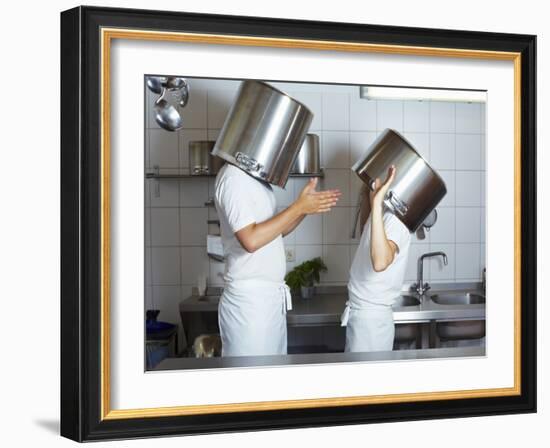 Two Chefs Having Discussion with Large Pans on their Heads-Robert Kneschke-Framed Photographic Print