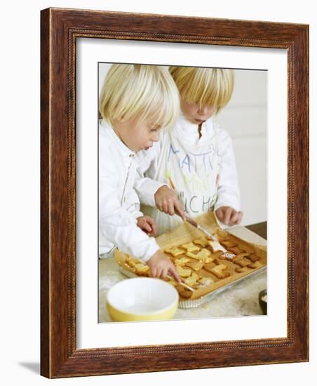 Two Children Brushing Biscuits with Glace Icing-Renate Forster-Framed Photographic Print