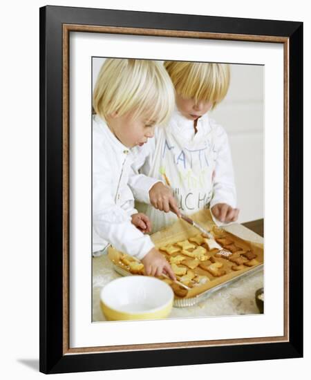 Two Children Brushing Biscuits with Glace Icing-Renate Forster-Framed Photographic Print