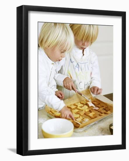 Two Children Brushing Biscuits with Glace Icing-Renate Forster-Framed Photographic Print