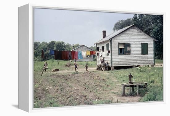 Two Children Stand in a Yard under a Laundry Line, Edisto Island, South Carolina, 1956-Walter Sanders-Framed Premier Image Canvas