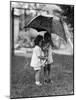 Two Children under Umbrella During a Downpour-Philip Gendreau-Mounted Photographic Print