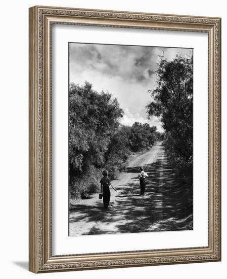 Two Children Walking Down a Dirt Road Going Fishing on a Summer Day-John Dominis-Framed Photographic Print