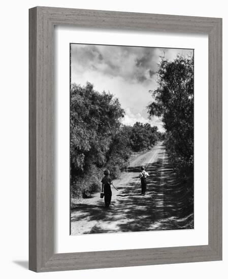 Two Children Walking Down a Dirt Road Going Fishing on a Summer Day-John Dominis-Framed Photographic Print