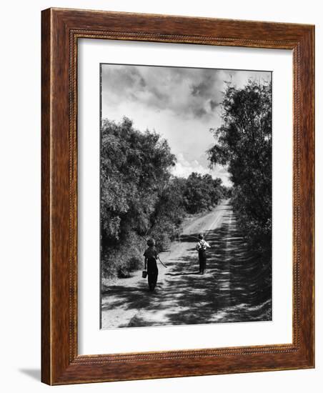 Two Children Walking Down a Dirt Road Going Fishing on a Summer Day-John Dominis-Framed Photographic Print