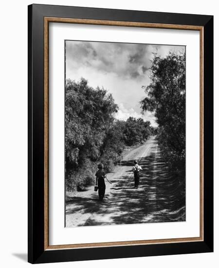 Two Children Walking Down a Dirt Road Going Fishing on a Summer Day-John Dominis-Framed Photographic Print