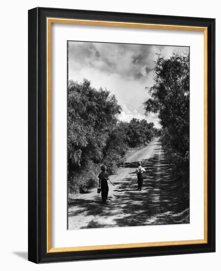 Two Children Walking Down a Dirt Road Going Fishing on a Summer Day-John Dominis-Framed Photographic Print