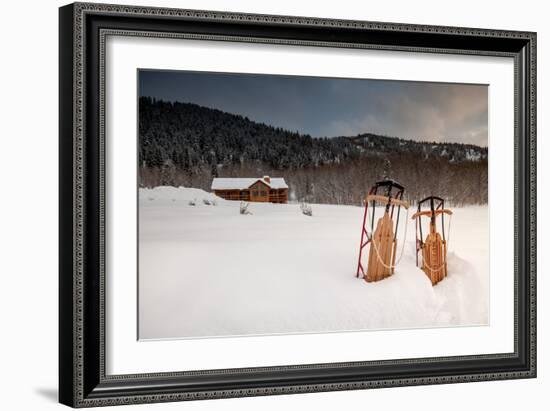 Two Classic Sleds In The Snow In Front Of A Cabin In The Mountains-Lindsay Daniels-Framed Photographic Print