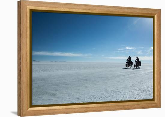 Two Cyclists Cycle in the Morning over the Salar De Uyuni-Alex Saberi-Framed Premier Image Canvas