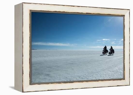 Two Cyclists Cycle in the Morning over the Salar De Uyuni-Alex Saberi-Framed Premier Image Canvas