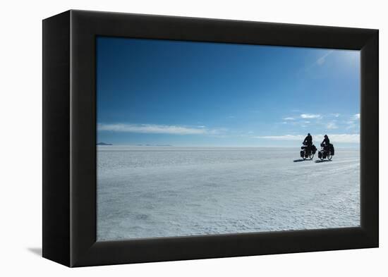 Two Cyclists Cycle in the Morning over the Salar De Uyuni-Alex Saberi-Framed Premier Image Canvas