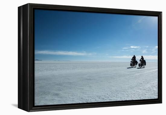 Two Cyclists Cycle in the Morning over the Salar De Uyuni-Alex Saberi-Framed Premier Image Canvas