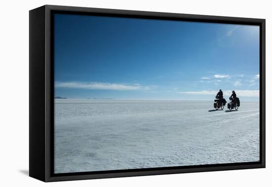 Two Cyclists Cycle in the Morning over the Salar De Uyuni-Alex Saberi-Framed Premier Image Canvas