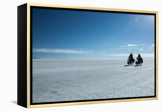 Two Cyclists Cycle in the Morning over the Salar De Uyuni-Alex Saberi-Framed Premier Image Canvas