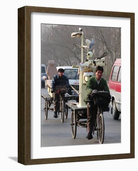 Two Delivery Riders Carry a Dentists Drill and Chair Along a Beijing Street January 4-null-Framed Photographic Print