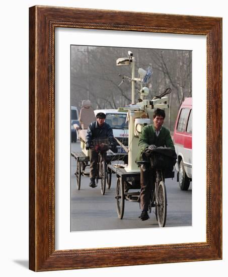 Two Delivery Riders Carry a Dentists Drill and Chair Along a Beijing Street January 4-null-Framed Photographic Print