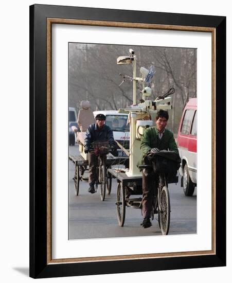 Two Delivery Riders Carry a Dentists Drill and Chair Along a Beijing Street January 4-null-Framed Photographic Print