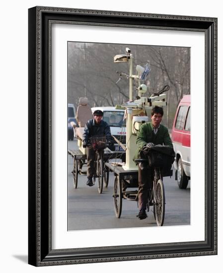 Two Delivery Riders Carry a Dentists Drill and Chair Along a Beijing Street January 4-null-Framed Photographic Print