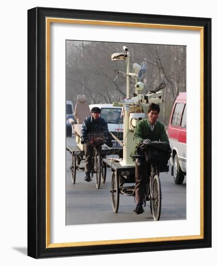 Two Delivery Riders Carry a Dentists Drill and Chair Along a Beijing Street January 4-null-Framed Photographic Print