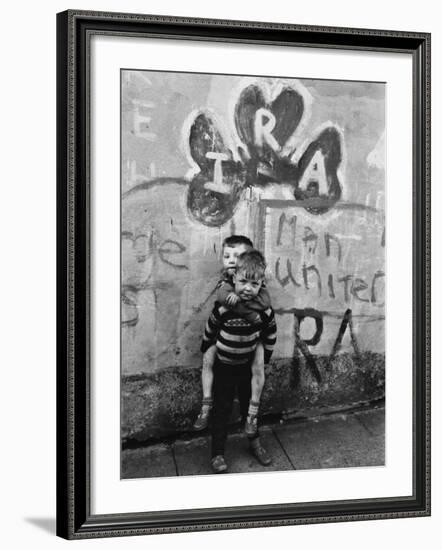 Two Dirty Boys Stand in Front of Ira Graffiti in Northern Ireland-null-Framed Photographic Print