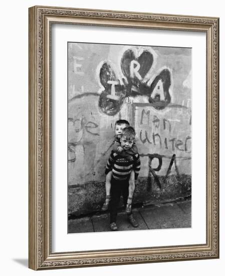 Two Dirty Boys Stand in Front of Ira Graffiti in Northern Ireland-null-Framed Photographic Print