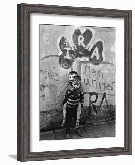 Two Dirty Boys Stand in Front of Ira Graffiti in Northern Ireland-null-Framed Photographic Print