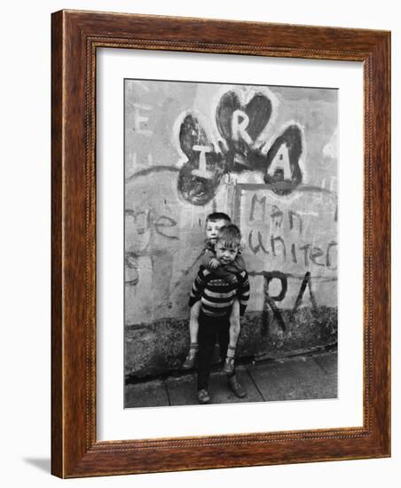 Two Dirty Boys Stand in Front of Ira Graffiti in Northern Ireland-null-Framed Photographic Print