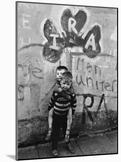 Two Dirty Boys Stand in Front of Ira Graffiti in Northern Ireland-null-Mounted Photographic Print