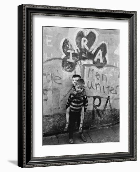 Two Dirty Boys Stand in Front of Ira Graffiti in Northern Ireland-null-Framed Photographic Print