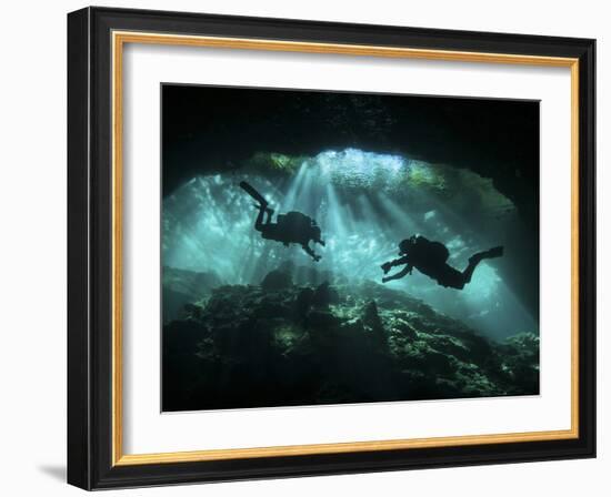 Two Divers Silhouetted in Light at Entrance to Chac Mool Cenote, Mexico-null-Framed Photographic Print