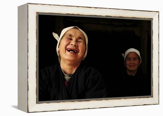 Two Dong Women, One Laughing, in a Dark Room, Sanjiang Dong Village, Guangxi, China-Enrique Lopez-Tapia-Framed Premier Image Canvas