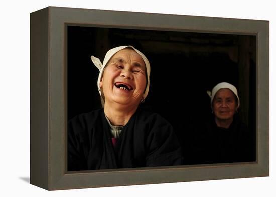 Two Dong Women, One Laughing, in a Dark Room, Sanjiang Dong Village, Guangxi, China-Enrique Lopez-Tapia-Framed Premier Image Canvas